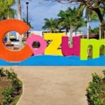 A colorful sign with the word cozumel in front of it. by Chasing the Sun Vacations