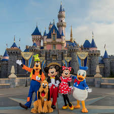 A group of Disney characters standing in front of Disneyland castle, creating a magical travel experience for all as an all-inclusive vacation destination. by Chasing the Sun Vacations
