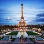 At dusk, book a cruise to marvel at the Eiffel Tower in Paris with the assistance of a travel advisor. by Chasing the Sun Vacations